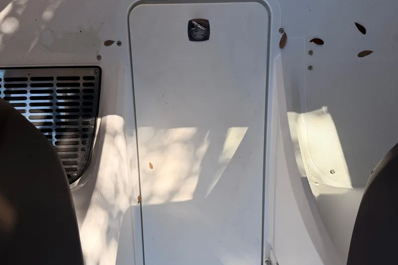 Slide: The Image of Interior of a 2017 Cobalt R3 boat, featuring a white panel and ventilation grille. - 27