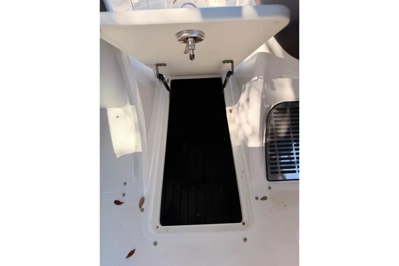 Slide: The Image of 2017 Cobalt R3 boat storage compartment with open hatch and visible interior. - 28