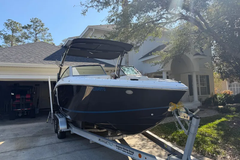 Slide: The Image of 2017 Cobalt R3 boat on trailer in driveway, near a house with trees. - 3