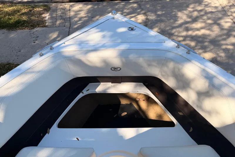Slide: The Image of Bow seating area of a 2017 Cobalt R3 boat, with white upholstery and shadow patterns. - 30