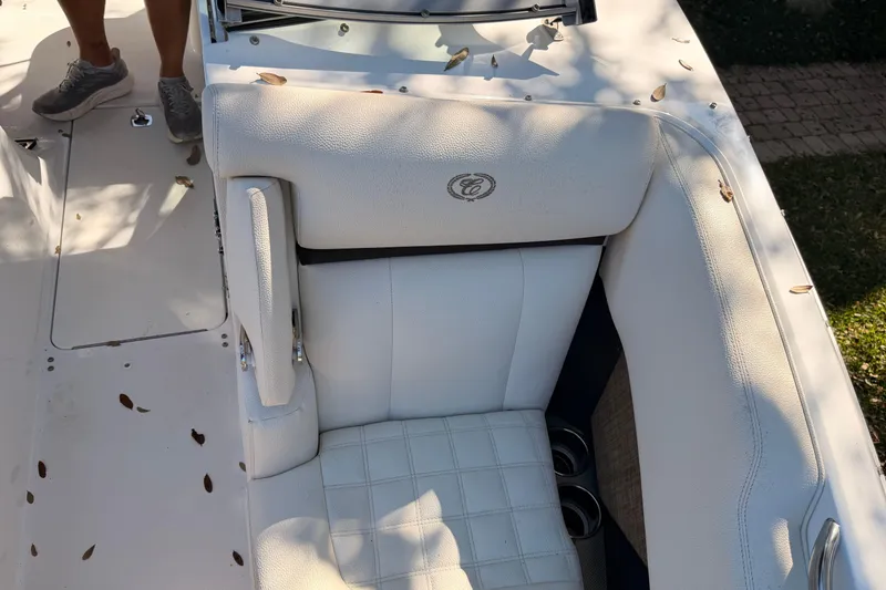 Slide: The Image of 2017 Cobalt R3 boat with white leather seating and cup holders, scattered leaves. - 31