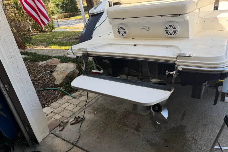 Slide: The Image of Rear view of a 2017 Cobalt R3 boat with swim platform and American flag. - 9