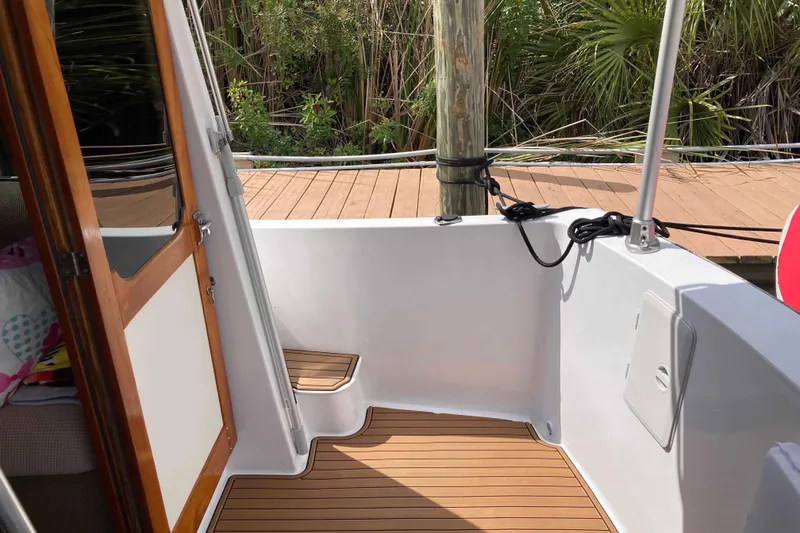 Slide: The Image of 1978 Prairie Boat Works 29 Coastal Cruiser helm with navigation equipment and scenic waterway view. - 10