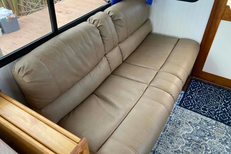 Slide: The Image of 1978 Prairie Boat Works 29 Coastal Cruiser interior with seating and life preserver. - 12