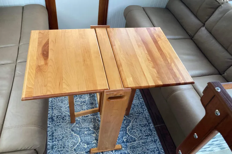 Slide: The Image of 1978 Prairie Boat Works 29 Coastal Cruiser interior with wooden flooring and open door. - 14