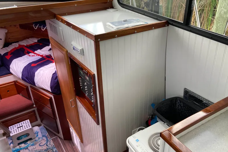 Slide: The Image of Interior of 1978 Prairie Boat Works 29 Coastal Cruiser with brown leather sofa. - 17