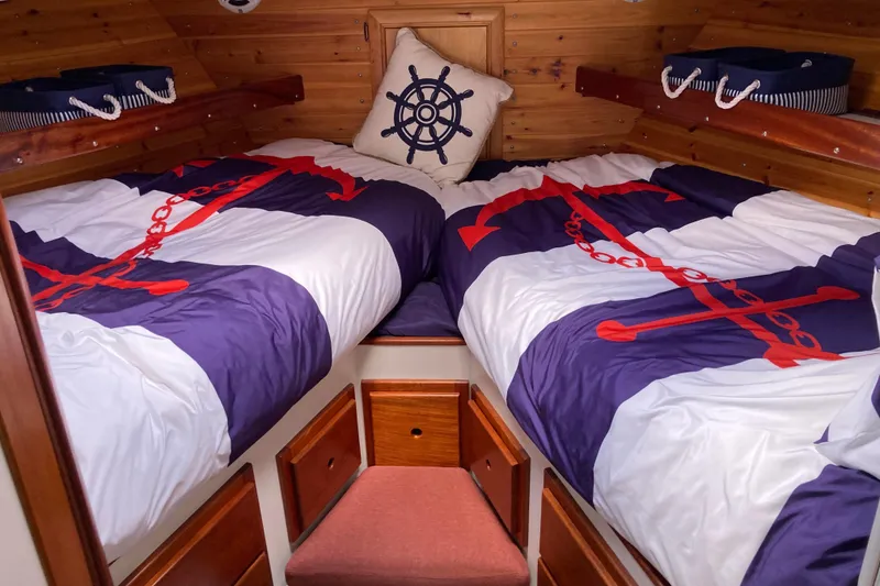 Slide: The Image of 1978 Prairie Boat Works 29 Coastal Cruiser interior with wood paneling and cozy sleeping area. - 19