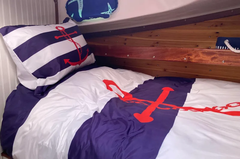 Slide: The Image of 1978 Prairie Boat Works 29 Coastal Cruiser interior with bed, storage, and control panel. - 21