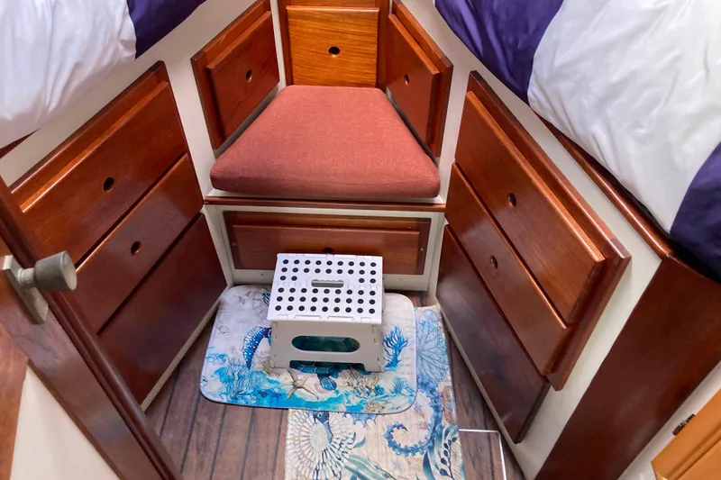 Slide: The Image of Cozy cabin interior of 1978 Prairie Boat Works 29 Coastal Cruiser with nautical-themed bedding. - 23