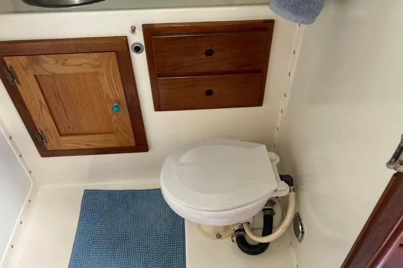 Slide: The Image of 1978 Prairie Boat Works 29 Coastal Cruiser cabin with wooden drawers and cushioned seat. - 26