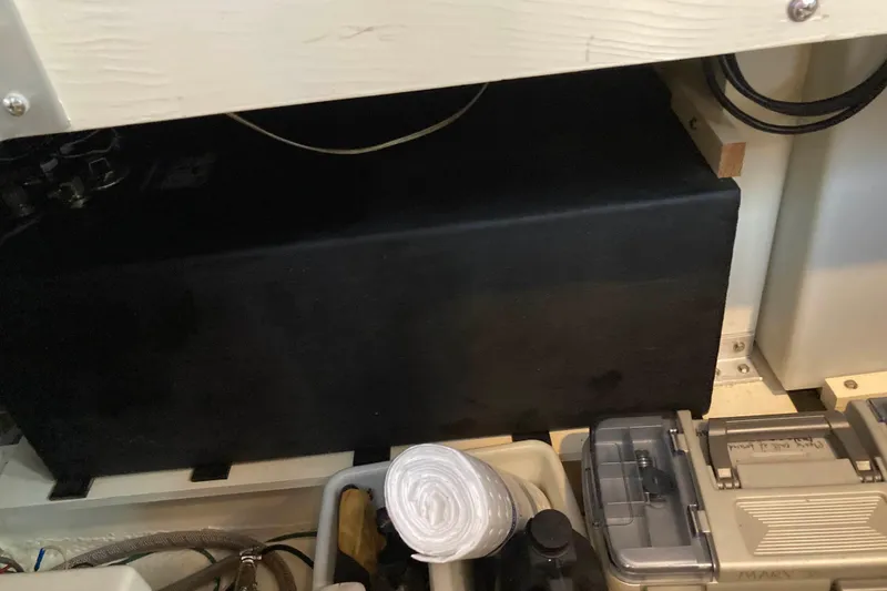 Slide: The Image of Storage compartment in a 1978 Prairie Boat Works 29 Coastal Cruiser with various equipment. - 32