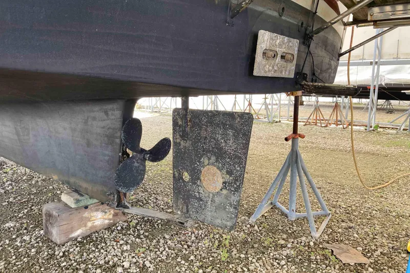 Slide: The Image of 1978 Prairie Boat Works 29 Coastal Cruiser under maintenance, showing propeller and rudder. - 33