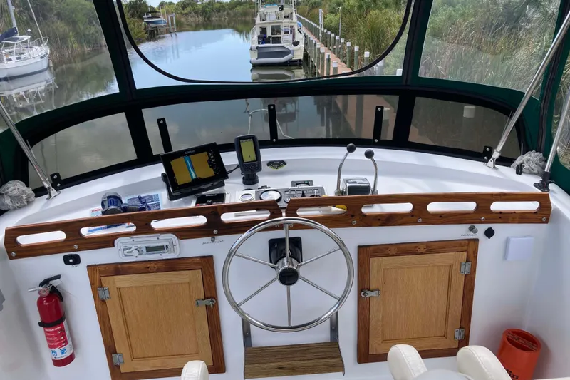 Slide: The Image of 1978 Prairie Boat Works 29 Coastal Cruiser under a canopy, side view. - 6