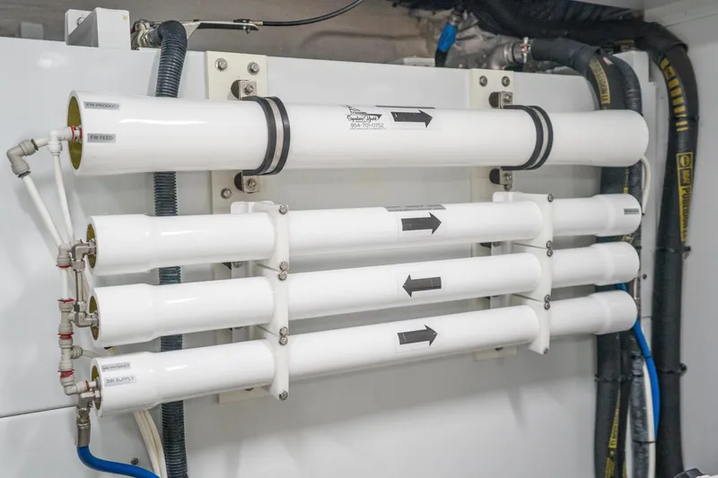 Slide: The Image of Water filtration system on a 2021 Princess Y85 yacht, featuring multiple white pipes and connectors. - 37