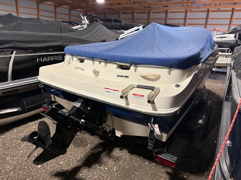 Slide: The Image of 2009 Sea Ray 175 boat with blue cover in storage facility. - 14