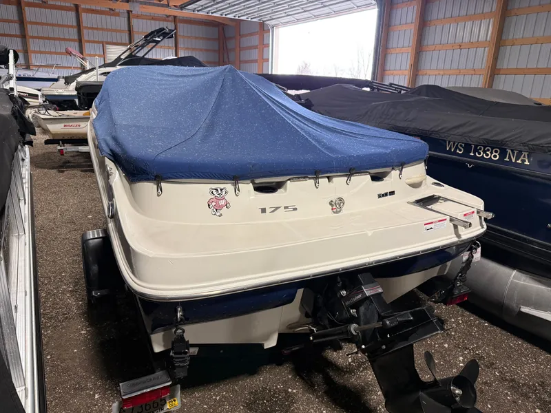 Slide: The Image of 2009 Sea Ray 175 boat with blue cover in storage facility. - 19