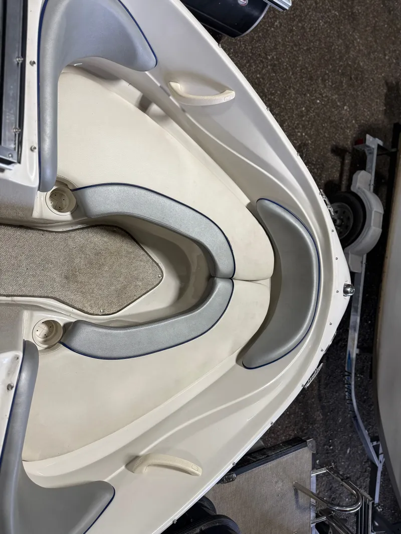 Slide: The Image of Interior of a 2009 Sea Ray 175 boat with gray upholstery. - 7