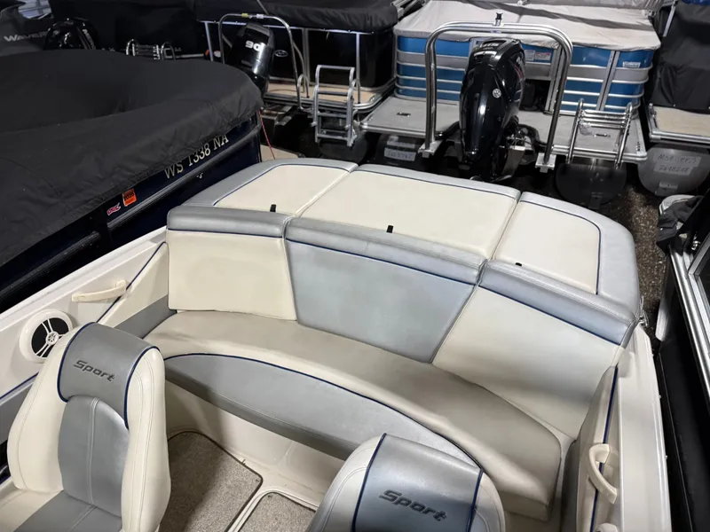 Slide: The Image of Interior of a 2009 Sea Ray 175 boat with gray and white upholstery. - 9