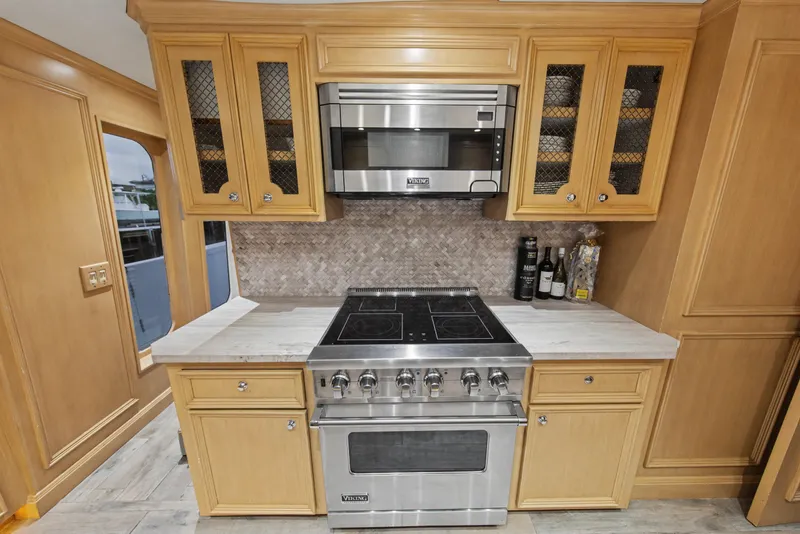 Slide: The Image of Kitchen interior of 2002 Ocean Alexander 120 Megayacht with modern appliances and cabinetry. - 26