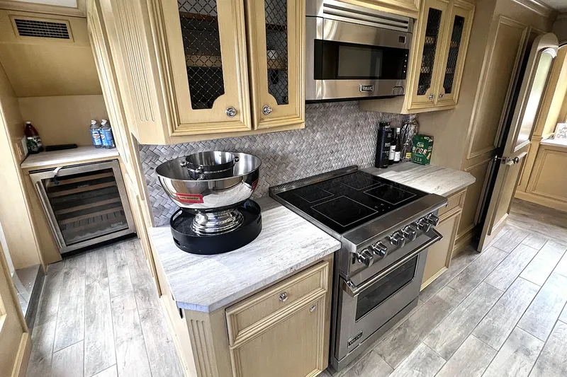 Slide: The Image of Luxurious interior of 2002 Ocean Alexander 120 Megayacht with modern kitchen and seating area. - 27