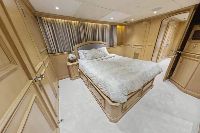 Slide: The Image of Luxurious bedroom interior of 2002 Ocean Alexander 120 Megayacht with elegant wood paneling. - 44