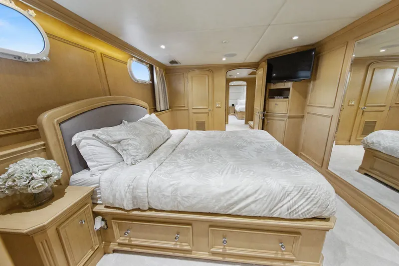 Slide: The Image of Luxurious bedroom interior of 2002 Ocean Alexander 120 Megayacht with elegant wood paneling. - 45