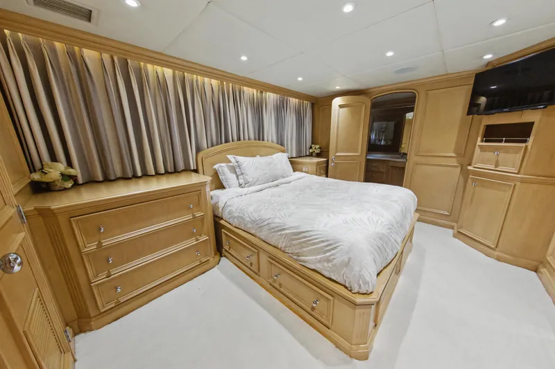 Slide: The Image of Luxurious bedroom on 2002 Ocean Alexander 120 Megayacht with elegant wood paneling and cozy bedding. - 48