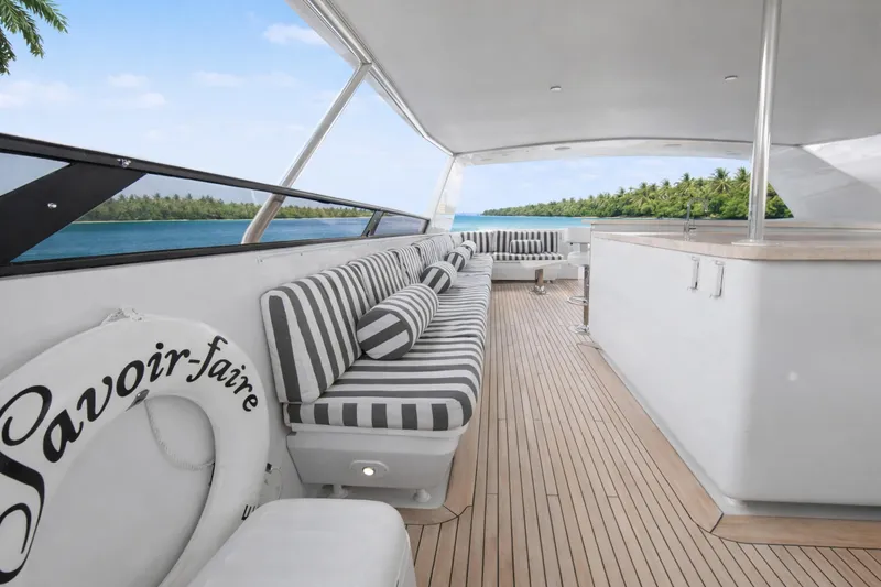 Slide: The Image of Luxurious Ocean Alexander 120 Megayacht deck with striped seating, bar stools, and scenic ocean view. - 61