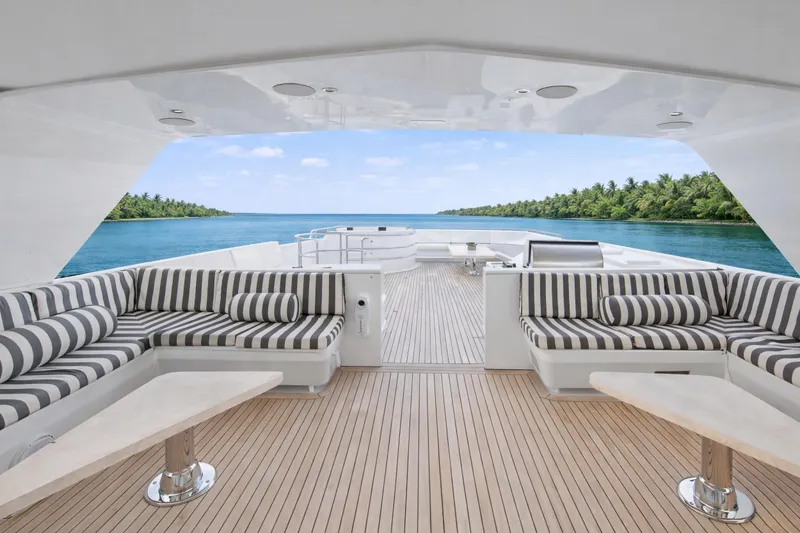 Slide: The Image of Luxurious Ocean Alexander 120 Megayacht deck with elegant seating, ocean view, and tropical surroundings. - 63