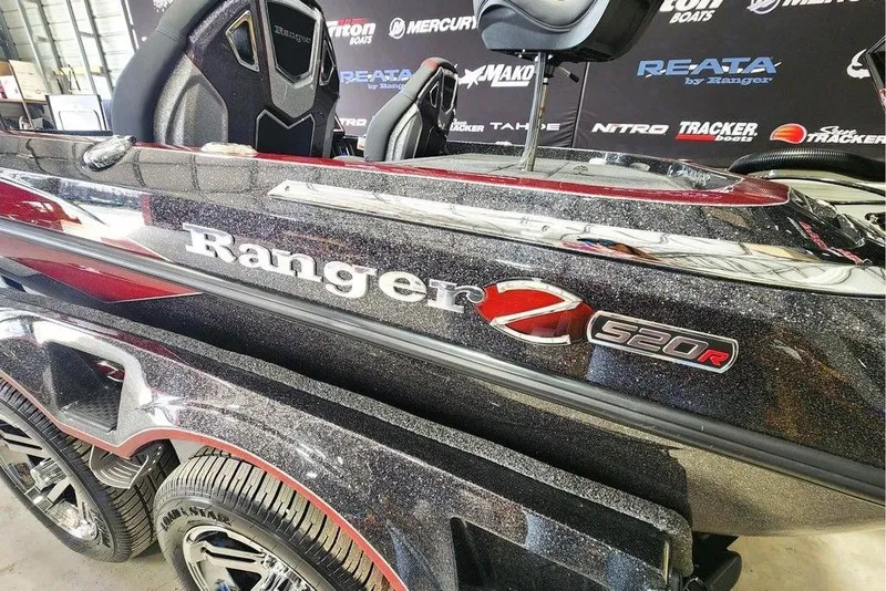 Slide: The Image of 2026 Ranger Z520R Cup-Equipped boat, sleek design with metallic finish, displayed indoors. - 9