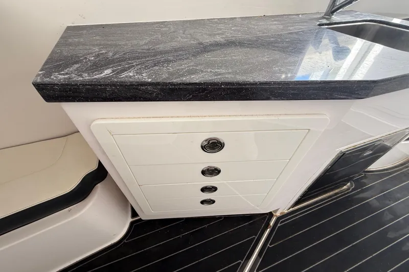 Slide: The Image of Streamline 45 boat interior with sleek black countertop and white drawers, 2020 model. - 102