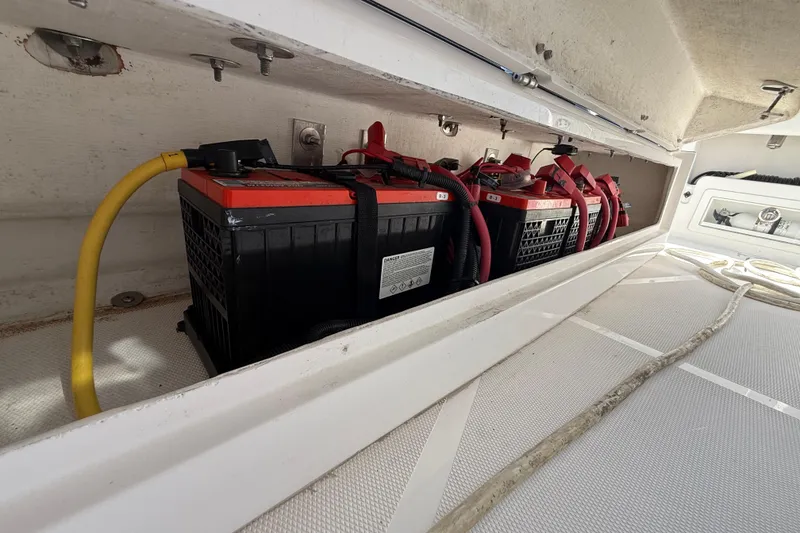 Slide: The Image of Battery compartment of a 2020 Streamline 45 boat with multiple batteries and cables. - 109