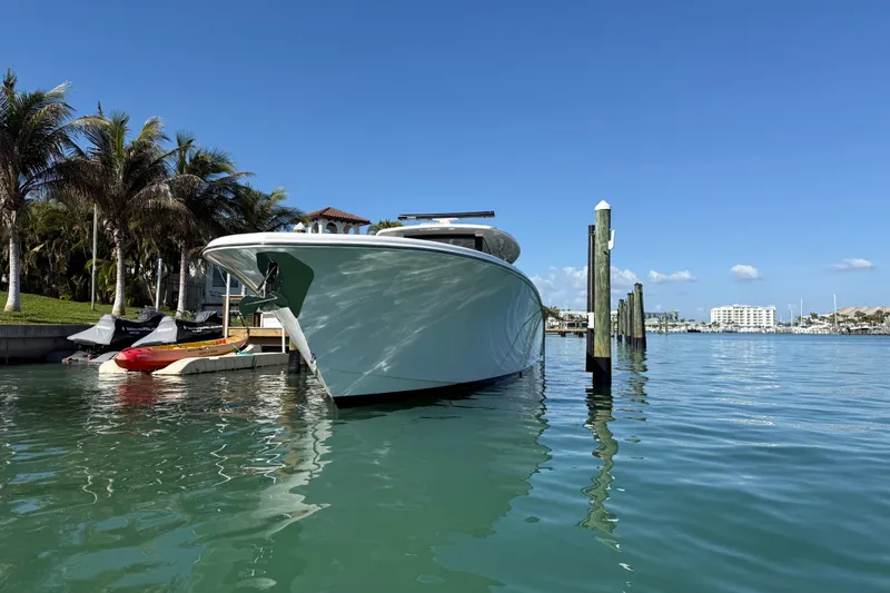 Slide: The Image of Streamline 45 yacht docked in sunny marina, surrounded by palm trees and clear blue sky. - 11