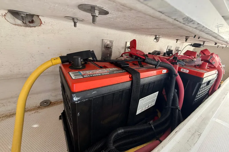 Slide: The Image of Battery compartment of a 2020 Streamline 45 with red and black cables. - 110