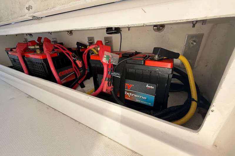 Slide: The Image of Battery compartment of a 2020 Streamline 45, featuring Odyssey Extreme batteries with red and yellow cables. - 112