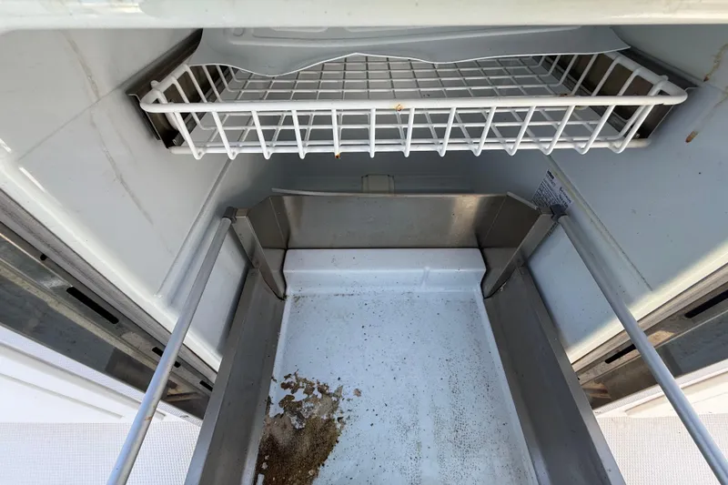 Slide: The Image of Open Streamline 45 freezer interior, showing empty wire shelf and bottom tray, 2020 model. - 114