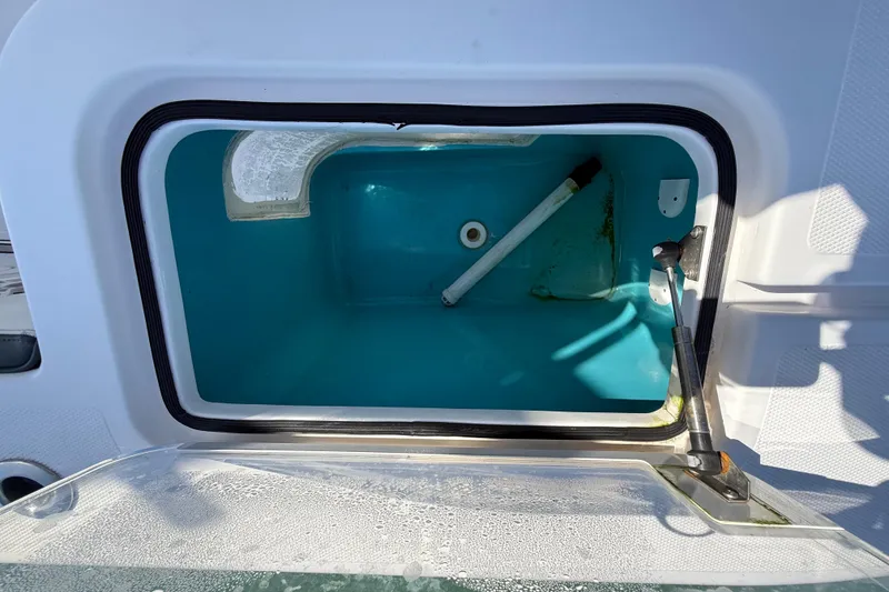 Slide: The Image of Open storage compartment on a 2020 Streamline 45 boat, featuring a blue interior. - 115