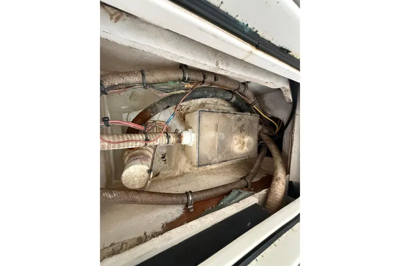 Slide: The Image of Interior view of a 2020 Streamline 45 engine compartment with visible wiring and hoses. - 132