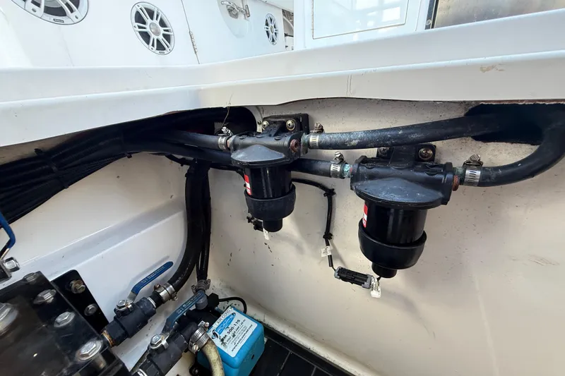 Slide: The Image of Engine compartment of 2020 Streamline 45 boat showing fuel filters and hoses. - 143