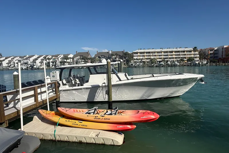 Slide: The Image of Streamline 45 boat docked with kayaks, waterfront view, 2020 model. - 18