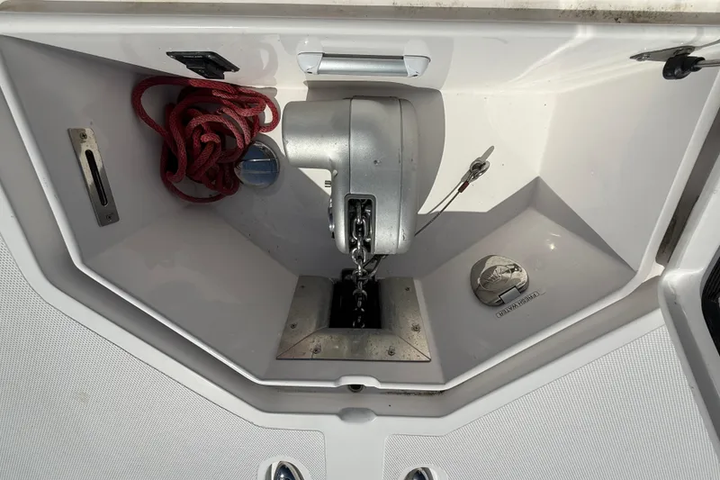 Slide: The Image of Anchor compartment of 2020 Streamline 45 boat with red rope and winch. - 26