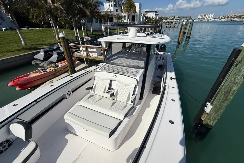 Slide: The Image of Streamline 45 boat docked in marina, showcasing sleek design and luxurious seating, 2020 model. - 31