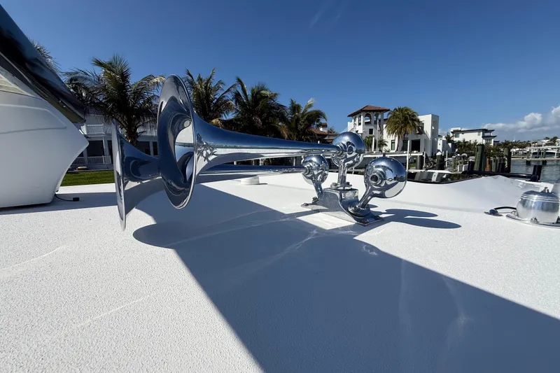 Slide: The Image of Chrome boat horn on 2020 Streamline 45 yacht, docked near palm trees and luxury homes. - 34