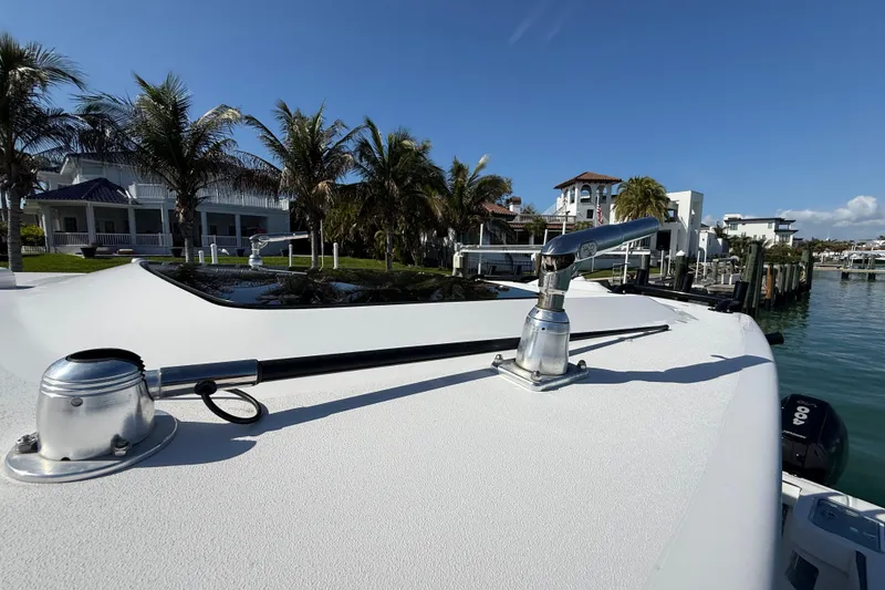 Slide: The Image of Streamline 45 boat deck with fishing outriggers, palm trees, and waterfront homes in the background. - 35