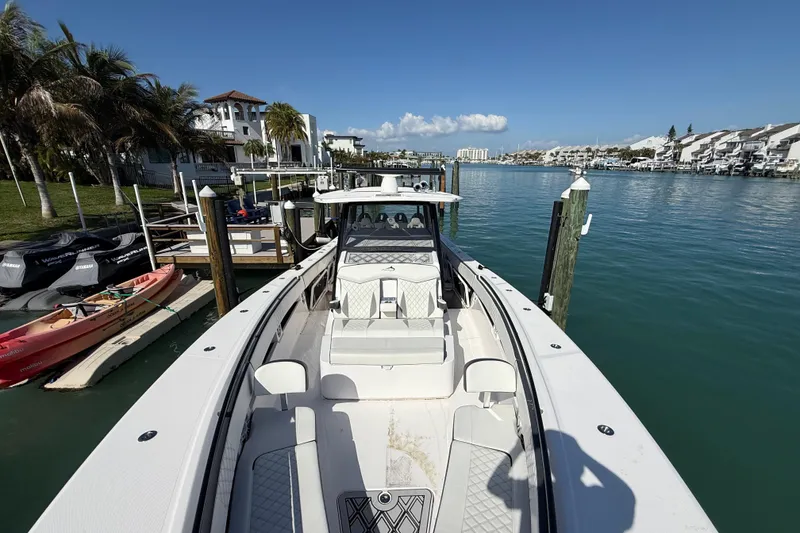 Slide: The Image of Streamline 45 boat docked in a scenic marina, surrounded by palm trees and waterfront homes. - 4