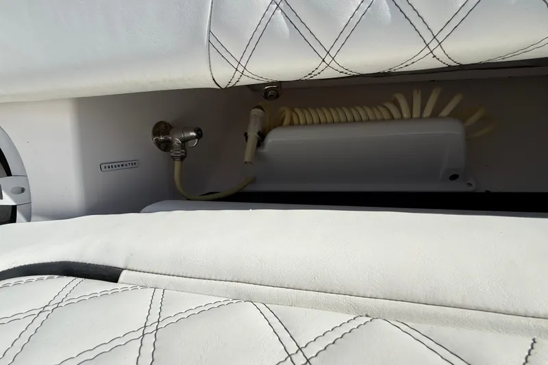 Slide: The Image of White leather interior of 2020 Streamline 45 with freshwater hose and fittings. - 40