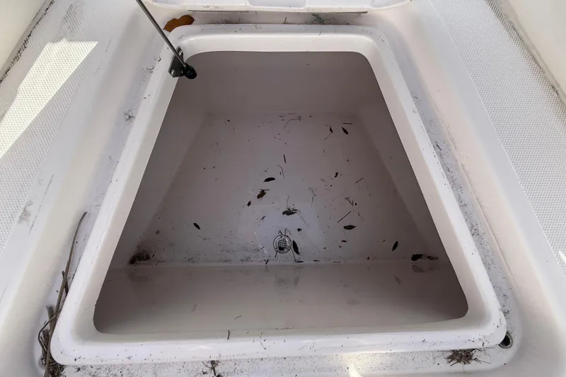 Slide: The Image of Open storage compartment of a 2020 Streamline 45 boat, containing leaves and debris. - 41