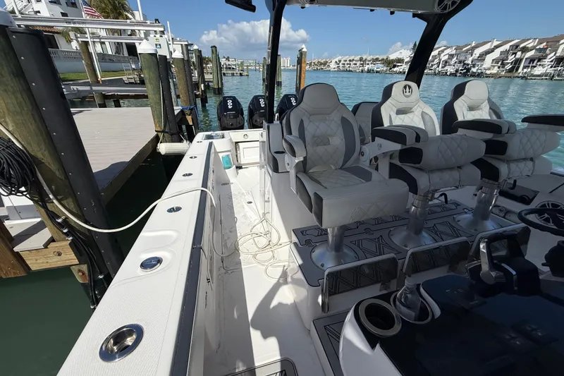 Slide: The Image of Luxurious 2020 Streamline 45 boat interior with plush seating, docked by clear blue water. - 50