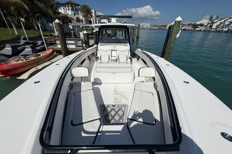 Slide: The Image of Luxury Streamline 45 boat docked in marina, showcasing sleek design and spacious seating, 2020 model. - 53