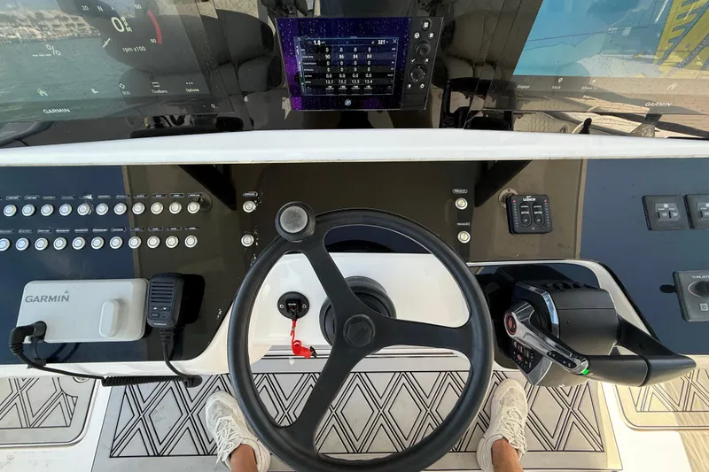 Slide: The Image of Cockpit of a 2020 Streamline 45 boat with Garmin navigation system and steering wheel. - 56